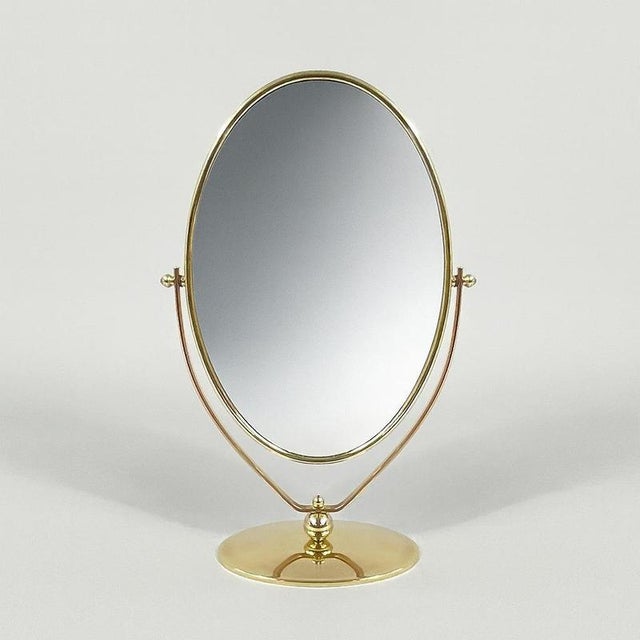 This elegant table mirror was designed and manufactured in Sweden in the 1940s. The mirror features an elegant oval shape...