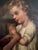 A charming and atmospheric 19th century European oil painting on canvas depicting an intimate domestic interior scene with...
