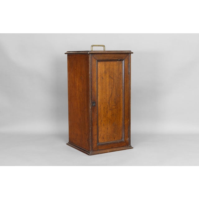 Mahogany slide/coin cabinet with inset brass carrying handle. Circa 1890.