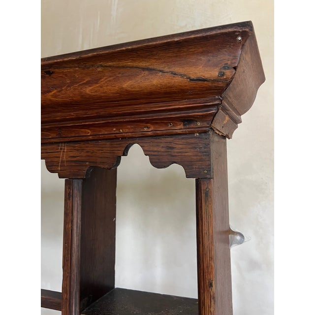 Late eighteenth century oak plate rack with a molded cornice over three shelves flanked by five smaller shelves on each...