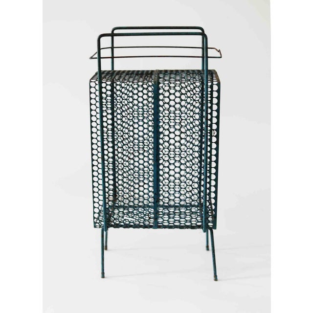 Vintage petite mid century modern magazine or book rack in original finish. Teal green original paint remains on the surface.