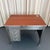This mid-century, industrial, brushed steel military desk circa 1940s features a newly clad, rust brown textured leather...