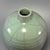 This antique Chinese Longquan celadon meiping vase features distinct horizontal ribbed lines across the body, covered in...