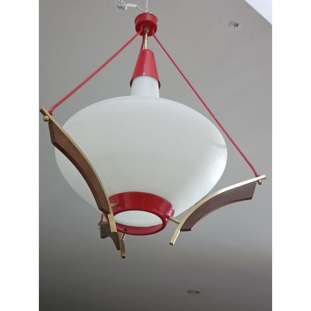 Magnificent pendant lamp in the style of Svend Aage Holm Sorensen. Denmark, 1960s. Red lacquered metal frame. Bentwood and...
