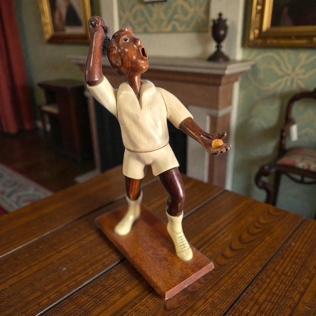 This vintage desk top Italian wood carving sculpture features a detailed tennis player design, standing at 12'' high....