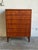 This tall storage piece features a sleek rectilinear silhouette housing six spacious pull-out drawers. Its clean...