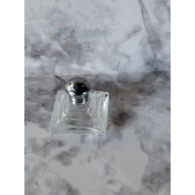 Vintage pyramid shaped single shaker. The shaker is made of press glass with a chrome top.