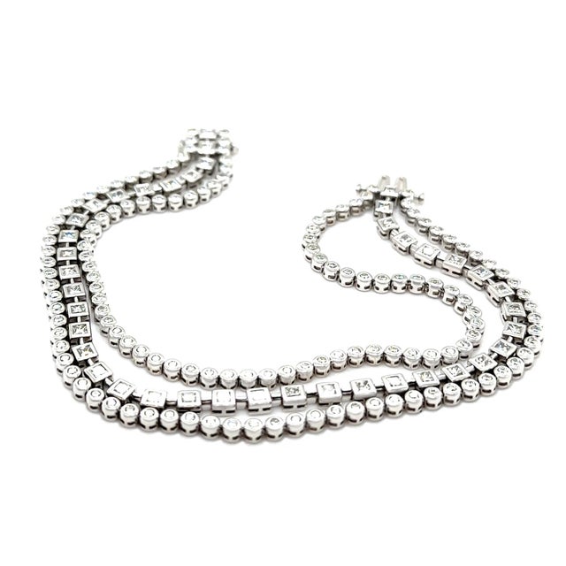 A luxurious diamond tennis bracelet crafted in 18ct white gold, featuring an impressive three-row design showcasing...