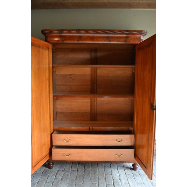 19th-century Dutch mahogany Biedermeier cabinet. The height is 212 cm. The width is 154 cm. The depth is 49 cm. Fully...