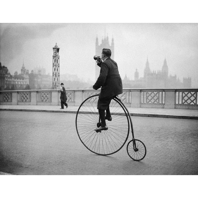 "Penny Farthing Bugle" by Fox Photos 17th October 1932: Edwin Davey, riding a penny farthing bicycle over Lambeth bridge...