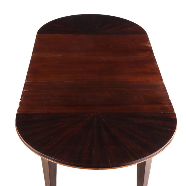 An exceptional dining table by André Domin and Marcel Genevrière for Maison Dominique, crafted in richly figured Macassar...