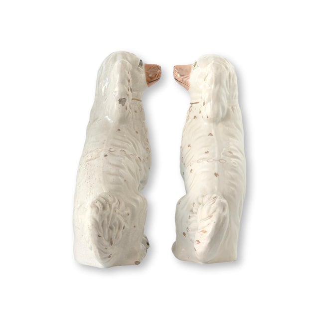 Circa 1860 large Staffordshire spaniels, modeled after Queen Victoria’s beloved Dash. Traditionally displayed on...