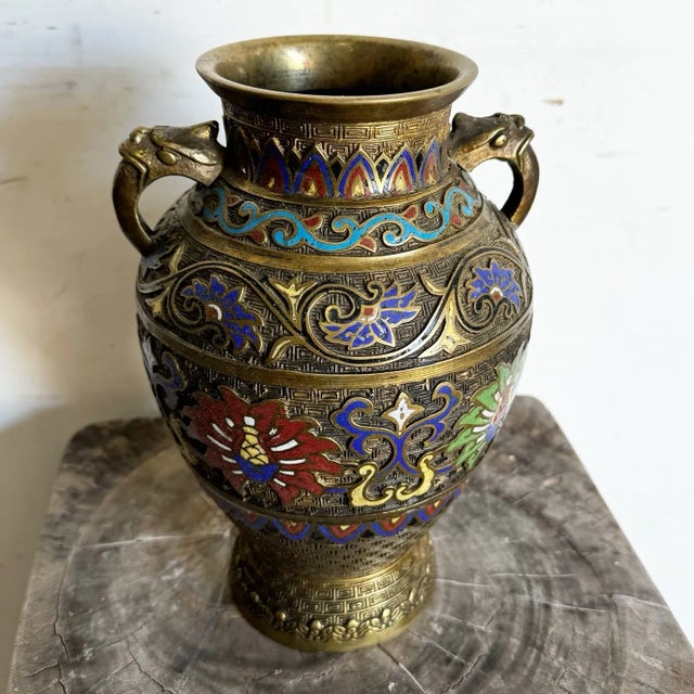 This exquisite antique Japanese Champlevé vase showcases intricate craftsmanship with vibrant enameled floral designs and...