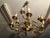 This is an art deco brass chandelier without light bulbs. Dimensions: diameter 66 / minimum height 67-87 cm maximum....