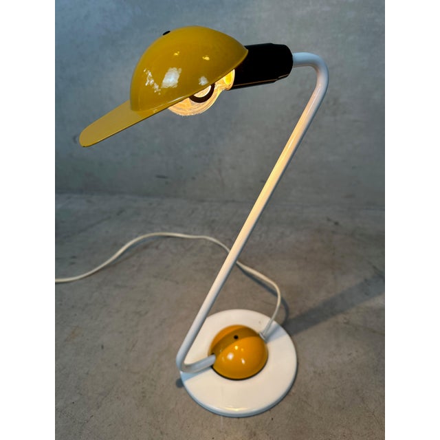 Striking postmodern table or desk lamp by Vrieland Design from the 1980s. A metal cap on the lamp allows you to direct the...