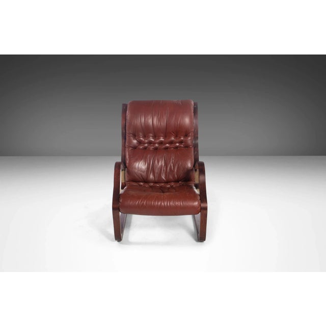 This absolutely exquisite 'Koivutaru' armchair with matching ottoman from the 70's in the rare combination of afromosia...