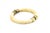 A smooth, rounded bone bangle bracelet in a warm ivory-yellow tone, accented with decorative gold-tone metal bands and...