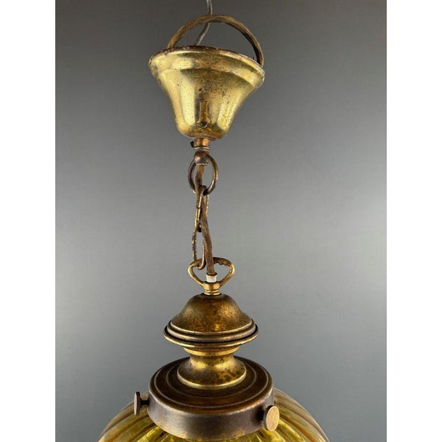 Charming pair of vintage amber blown glass pendant lights dating from the 20th century. These timelessly elegant lights...