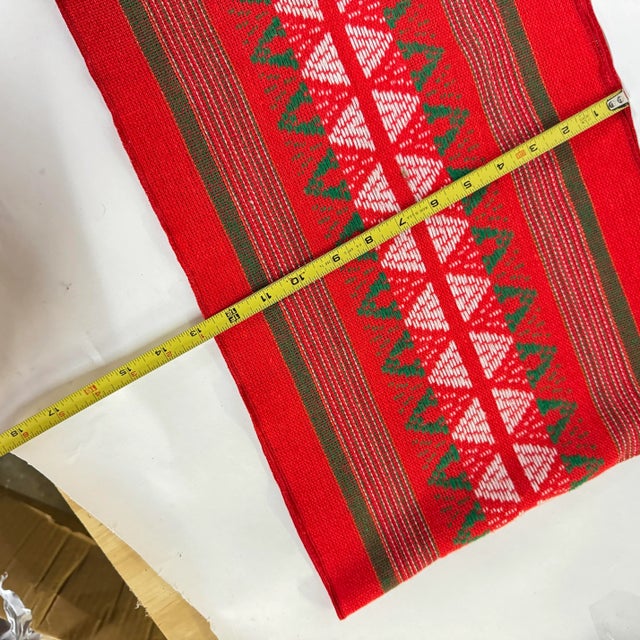 Table runner in green, white, red with a subtle metallic gold threading, measures just over 86 inches. In good condition....