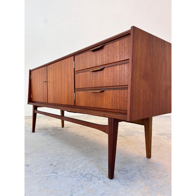 This German-made sideboard showcases the straightforward functionality and timeless aesthetic of mid-century design. The...