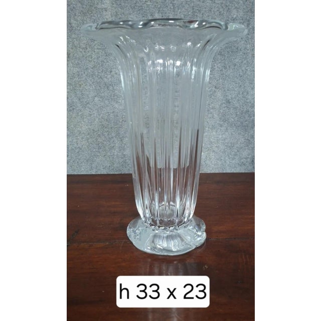 Daum France crystal vase, featuring a flared silhouette enhanced by a finely crafted vertical ribbed design. The gently...
