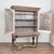 This stately baroque cabinet stands on four turned legs with an "x-cross" stretcher resting on large bun feet that raise...