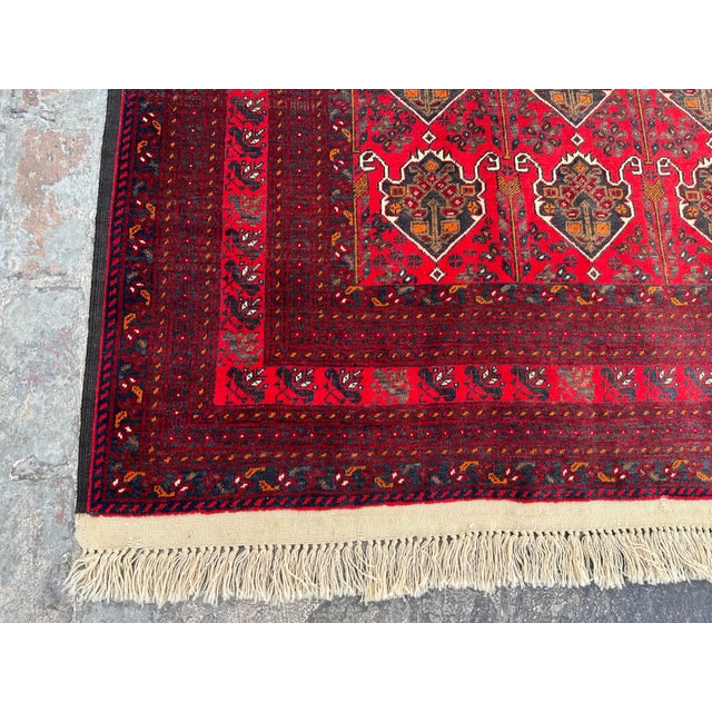This hand-knotted Afghan rug uses natural colors and handspun wool. This lovely rug will enhance your home's style. This...