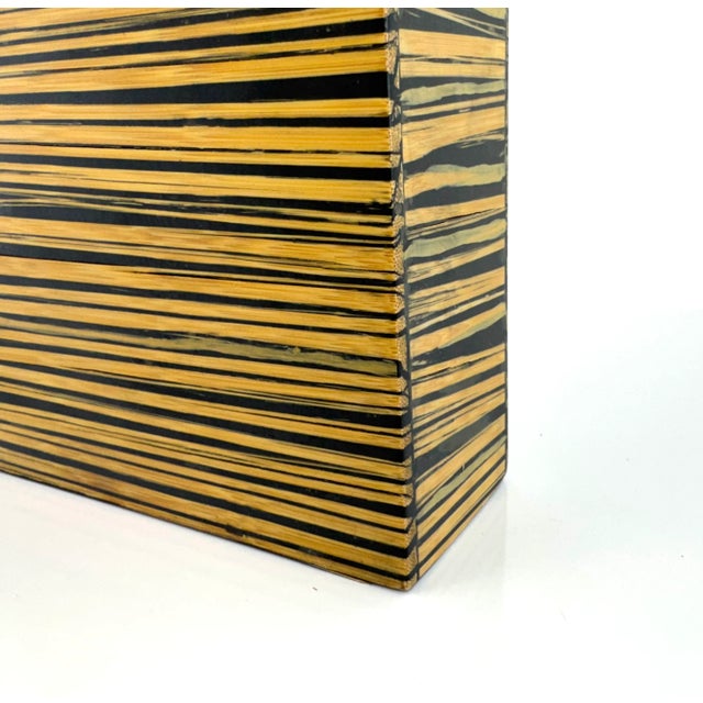 Bold and architectural, this tall rectangular vase features a dynamic striped pattern of laminated bamboo veneer over a...
