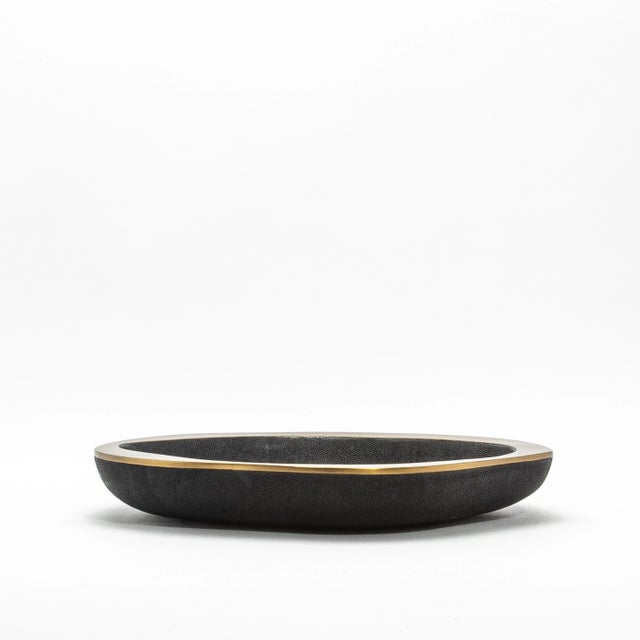 The Lily Bowl in black shagreen with bronze patina brass by R&Y Augousti exudes refined elegance through its striking...