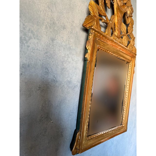 Unique 18th century French gilded mirror. Beautiful floral carved pediment.