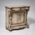 Half cabinet with a single door featuring a shaped panel, curved corner ornaments, and a drawer with carved shell...