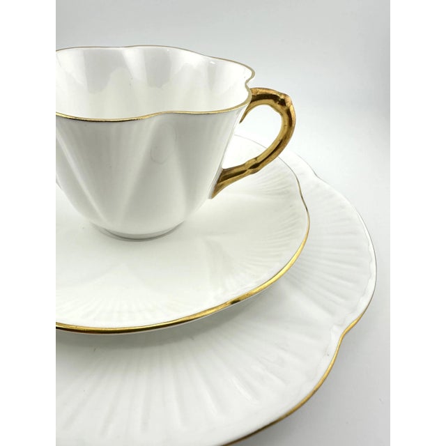 This lovely Shelley Regency White trio includes a cup, saucer, and plate in Shelley’s iconic Dainty shape. The delicate...