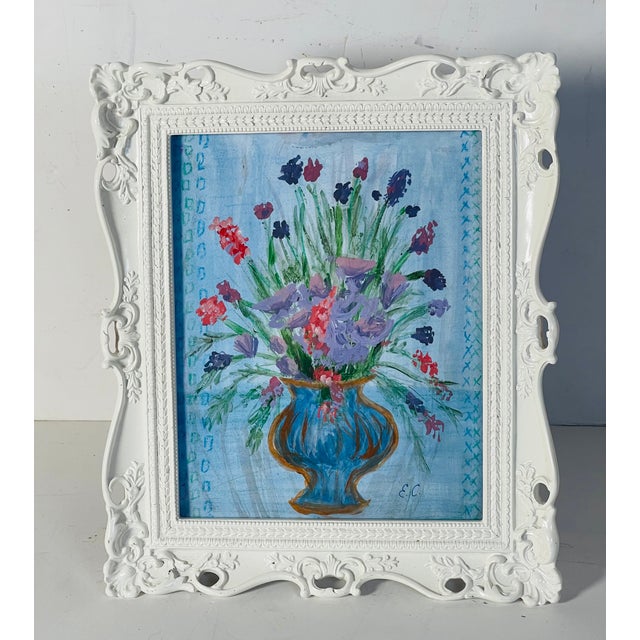 Abstract still life if Floweers in vase on blue background by Elia in ornate reticulated white frame.