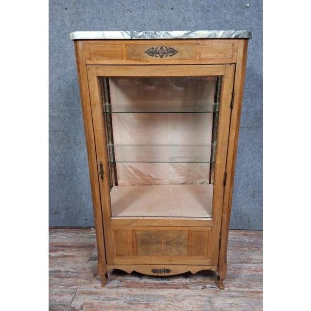 Louis XV Transition style marquetry display cabinet. Light wood, elegant and understated, opening with a glazed door on...