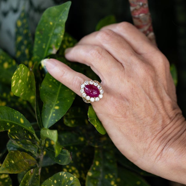 18k Ring with AGL certified 7.98 carat Burma Ruby Cabochon and 18 round diamonds weighing 4.08 carats and 10 baguette...