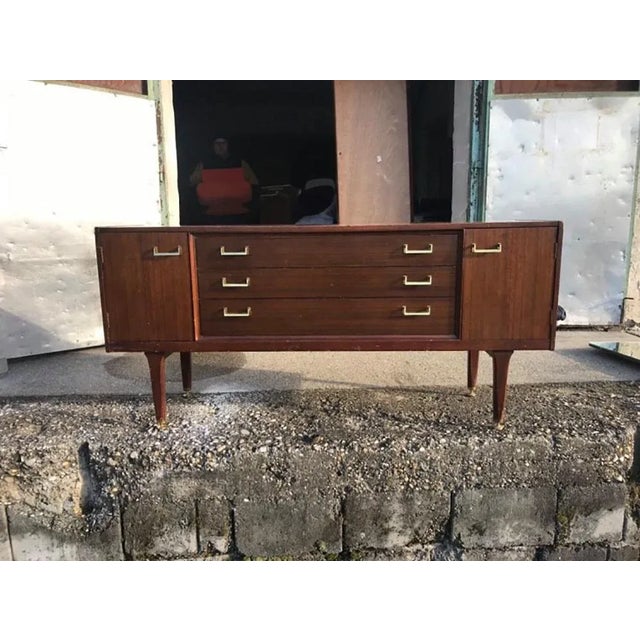 Designed by E Gomme and made by G Plan. The sideboard has three drawers in the middle next to cupboard doors. I have...