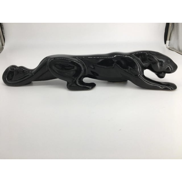 This sleek sculpture of a crouching panther sneaking up on its prey would add class to any bookshelf or table. Fairly...