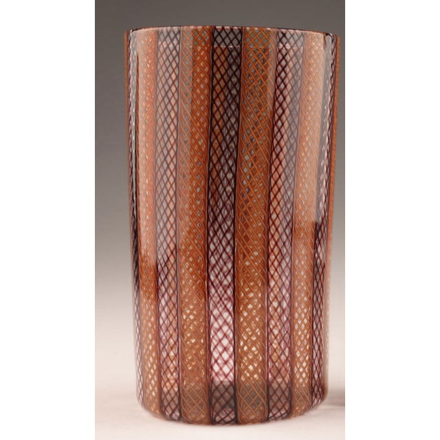 Murano Zanfirico Filigrana vintage blown glass vase, in the manner of Venini. Features warm amber and inky tones of...