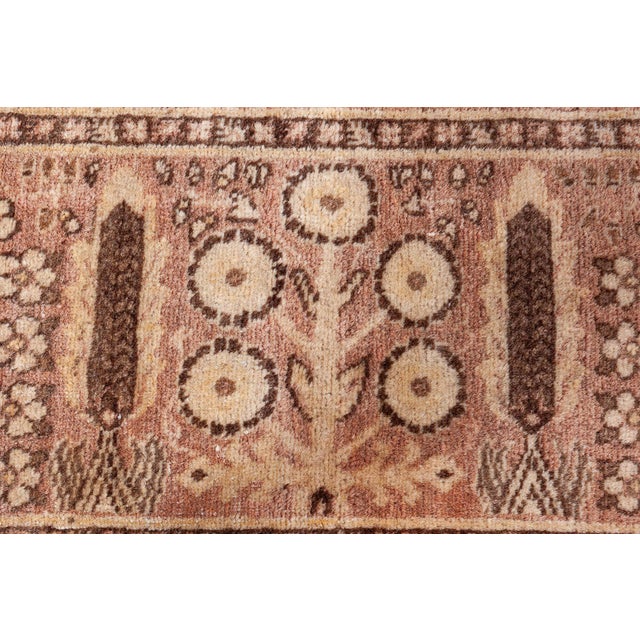 An early 20th century Persian Tabriz antique rug, the caramel field with an allover trellis of scrolling flowering vinery,...