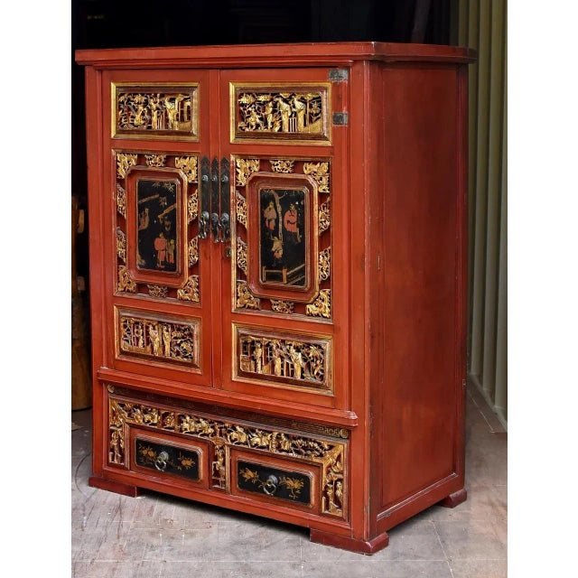 This rare, magnificent, fully carved, gilded cabinet was a scholar's treasure chest. Hand painted door panels depict the...