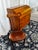 A distinctive vintage writing set featuring a traditional roll-top secretary desk and coordinating wooden chair with...