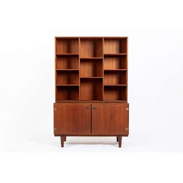 This Danish modern teak bookcase cabinet was designed by Peter Løvig Nielsen and produced by Løvig Dansk Designs in...