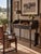 Antique primitive writing desk with raised gallery sides, divided cubbies, a wide center drawer, and slender turned legs....