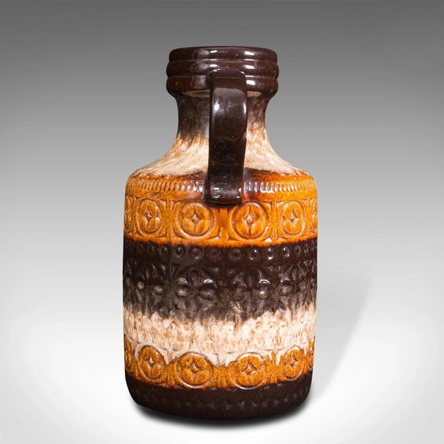 This is a colourful vintage decorative jug. A German, ceramic lava pattern serving ewer or vase, dating to the mid 20th...