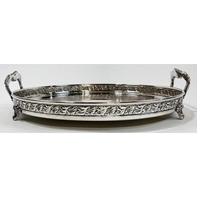 Beautiful vintage etched shell pattern on round footed tray made of silver plate over copper. Handles to two sides and 4...