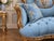 This elegant circa 1920 French Louis XVI–style settee combines antique craftsmanship with rich blue velvet, a finely...