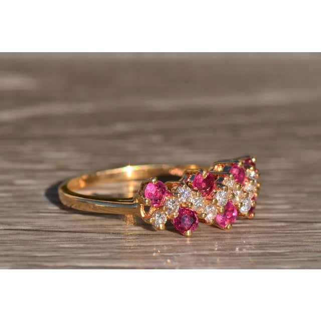 The Owena Ladies Contemporary 14K Yellow Gold Natural Ruby and Diamond Zig Zag Band. This colorful band features 0.50...