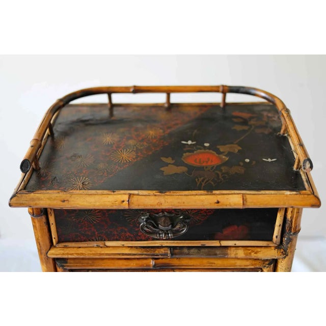 Antique English bamboo side table cabinet with single drawer and wire mesh door that opens to storage area with two...