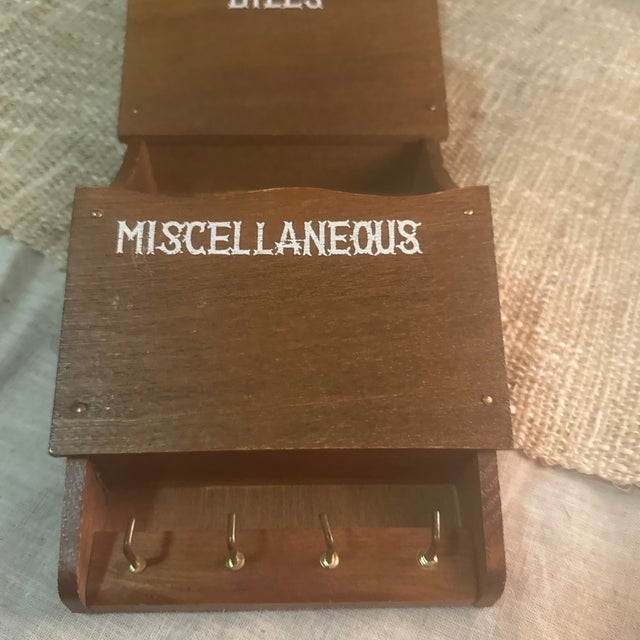 Crafted in richly toned wood with visible natural grain, the vertical design features three open compartments perfect for...