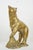 Vintage brass black bear standing proudly with its right front paw elevated onto a rugged, textured rock formation. Great...